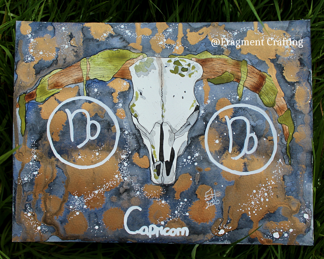 An original watercolour painting of a Capricorn star sign with a grey and orange background and white sea goat skull being shown off on the grass.