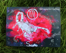 Load image into Gallery viewer, A print copy of a Scorpio star sign watercolour painting with a red background and white scorpion skeleton being showed off on the grass.
