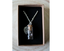 Load image into Gallery viewer, A boxed silver necklace with a leaf and small corked bottle of smokey quarts crystals.
