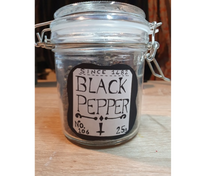 Load image into Gallery viewer, A black and white sticker of a label for black pepper being showcased on a jar.

