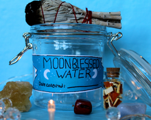 Load image into Gallery viewer, A blue moonblessed water sticker being showcased on a jar.
